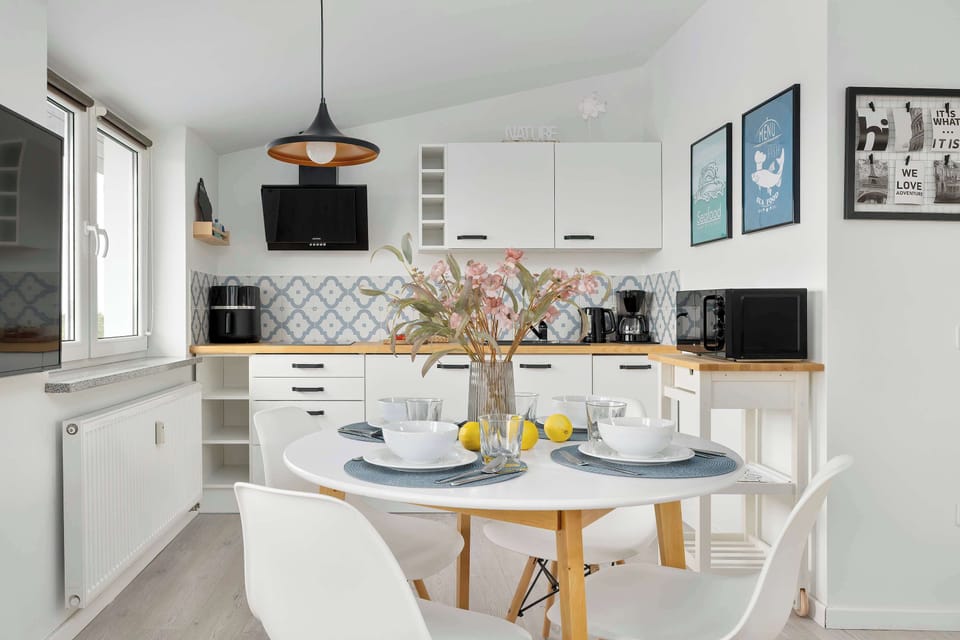 Stylish kitchenette and dining area in a bright, open-plan living space.