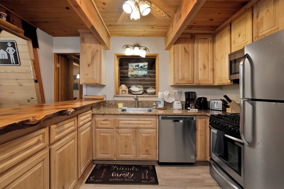 Fully equipped cabin kitchen with ample cabinetry, stove, fridge, and coffee maker—perfect for cooking meals, morning coffee, and feeling right at home on your stay.