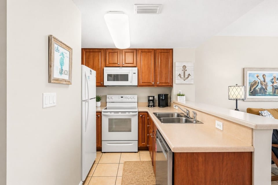 Your fully equipped kitchen features warm wood cabinetry, modern appliances, and all the essentials for preparing memorable vacation meals together.