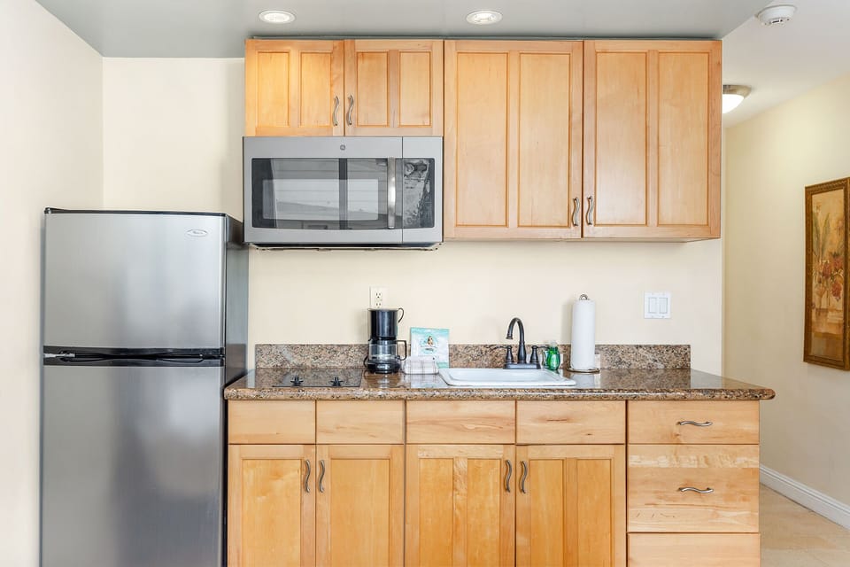 Your fully equipped kitchenette features warm maple cabinetry, granite counters, stainless appliances, and everything you need for easy meal prep during your stay.