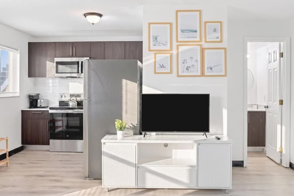 Relax and unwind in the bright living room with comfortable seating, a Smart TV, and plenty of space to gather.