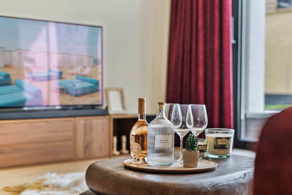 Cozy lounge corner with welcome refreshments, a smart TV and warm furnishings in this luxury 2-bedroom holiday apartment in De Haan, where comfort meets style just minutes from the North Sea beach.