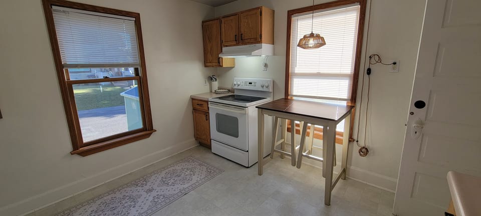 Kitchen with stove, extra prep space, and a small table for coffee, snacks, or planning the day.