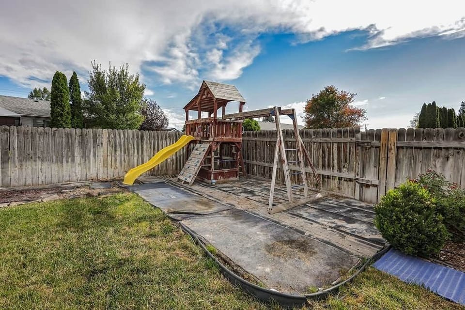 Backyard playset with slide and climbing deck kids will love