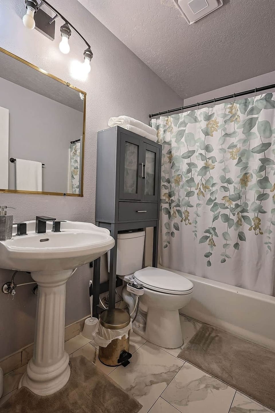 Fresh, leafy bathroom with soft lighting, fluffy towels, and a relaxing tub