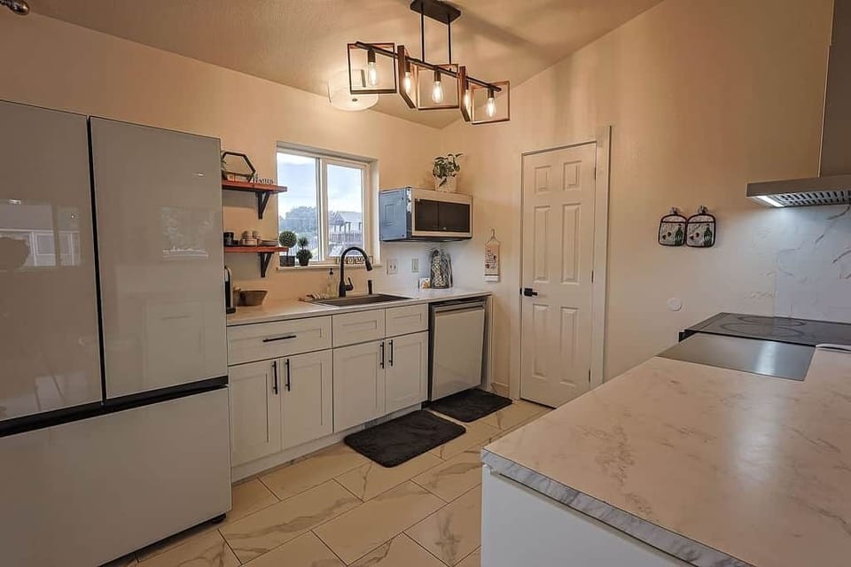Updated kitchen with modern appliances, ample counter space, and backyard views