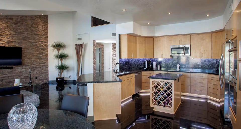 Large fully equipped kitchen, overlooks swimming pools & second Living + 85" TV