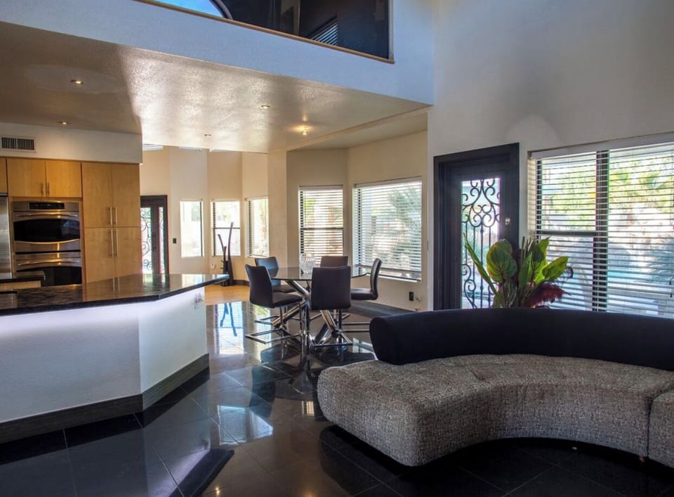Large fully equipped kitchen, overlooks swimming pools & second Living + 85" TV