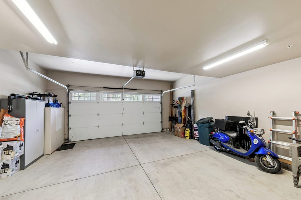 A spacious two-car garage with ample storage and bright overhead lighting provides convenient parking and organized space for your gear and equipment during your stay.