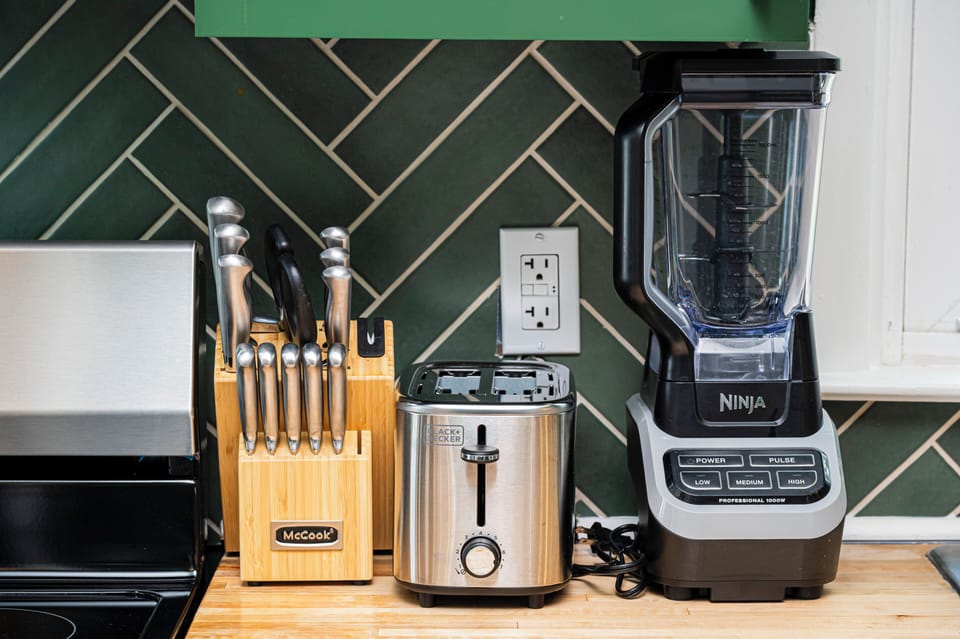 Stylish, well-equipped kitchen with knife set, toaster, and powerful blender.