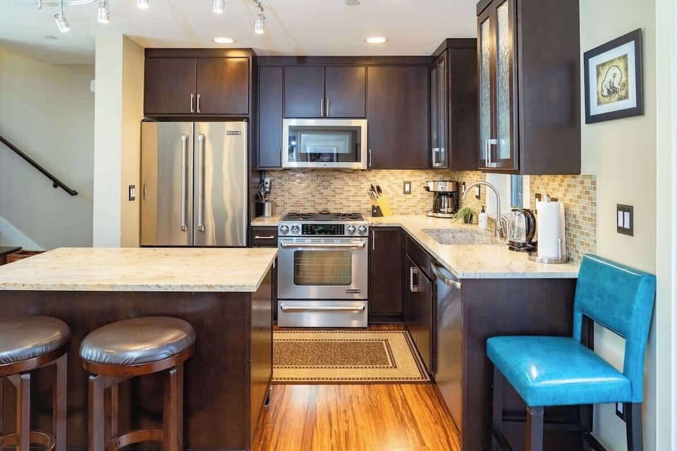 Modern kitchen features high-end appliances and gas range 