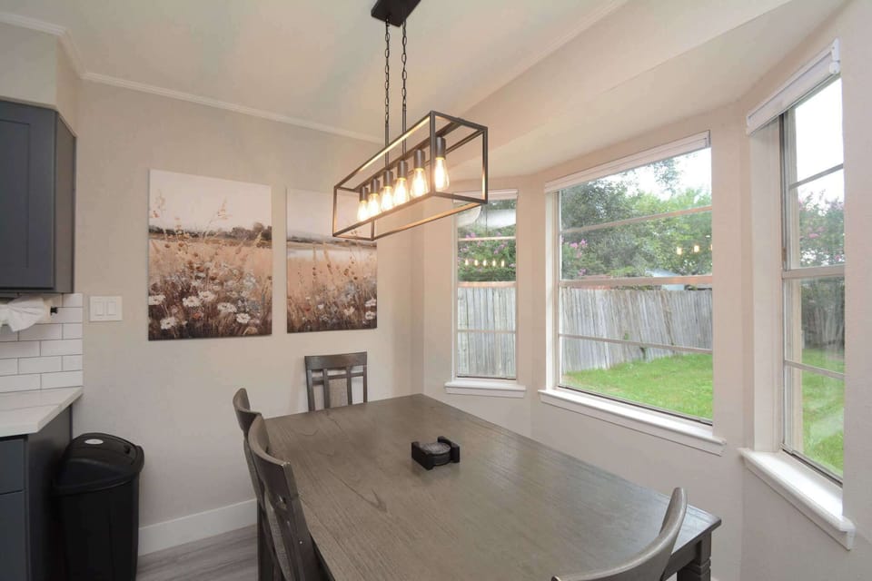 Dining table has 4 comfy chairs & a bench for sharing meal time together.