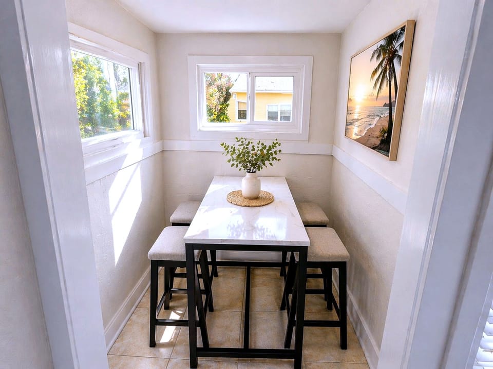 Sunny breakfast nook with window views and sleek bistro table