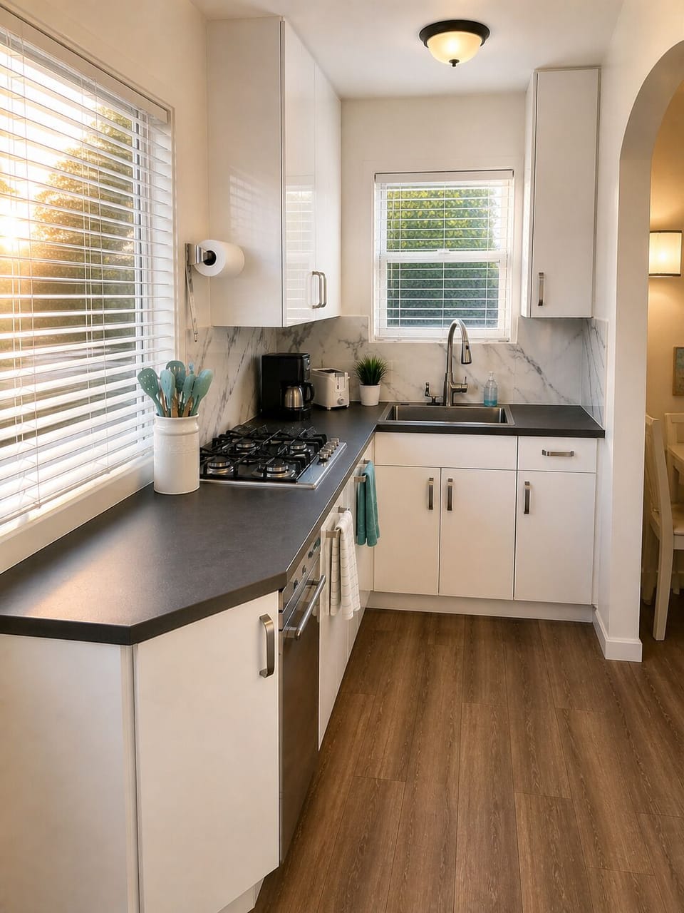 Sunlit, modern galley kitchen with gas cooktop and dishwasher
