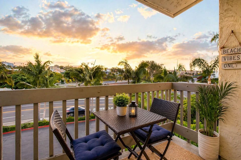 Cozy balcony retreat with sunset views and palm-lined coastal vibes.