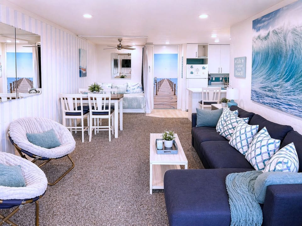 Bright coastal suite with plush seating, dining nook & kitchenette
