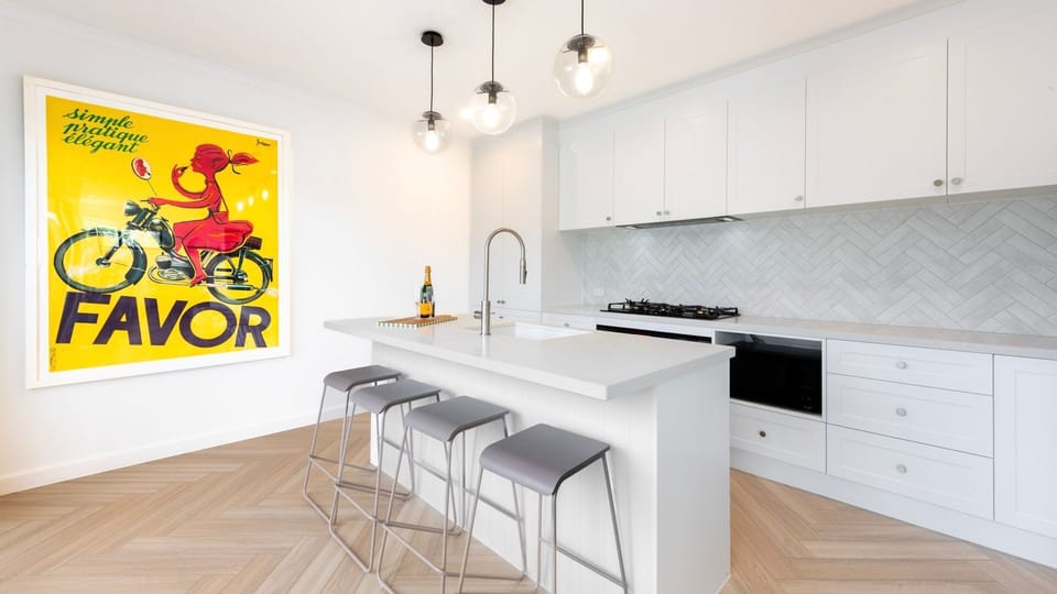 Cook your favourite meals in the sleek, modern kitchen featuring quality appliances and ample bench space.