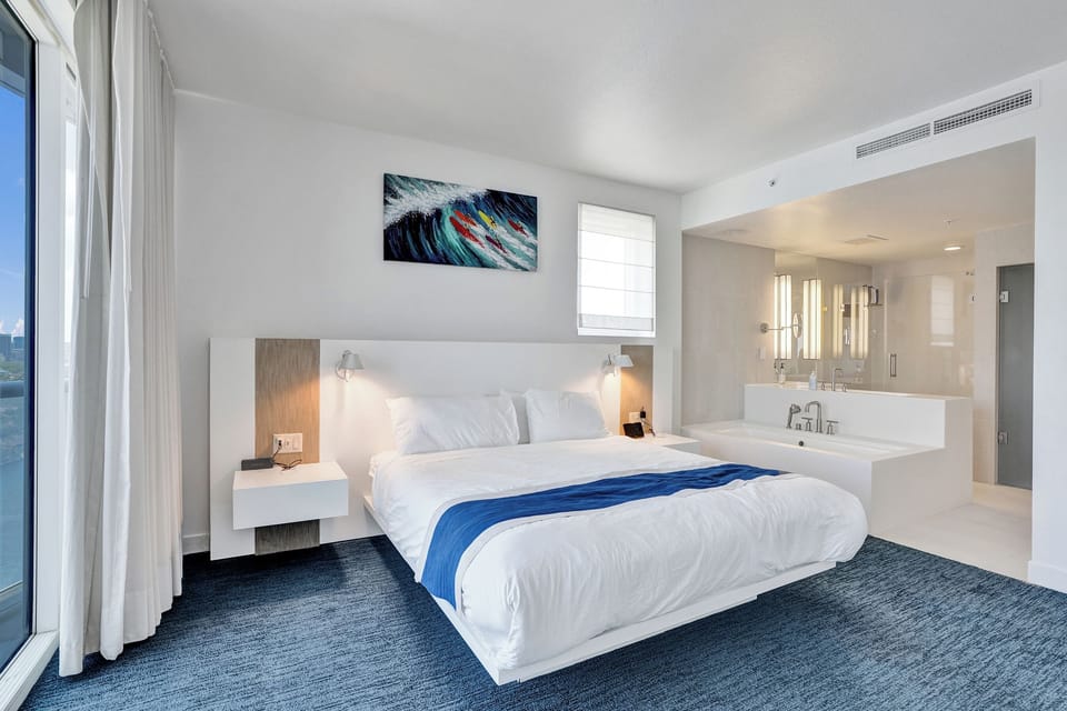 Cozy bed framed by windows and balcony doors so you never lose sight of the view.
