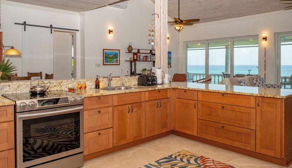 Appliances include a refrigerator/freezer, dishwasher, microwave, toaster, coffee pot, tea kettle and various culinary appliances.