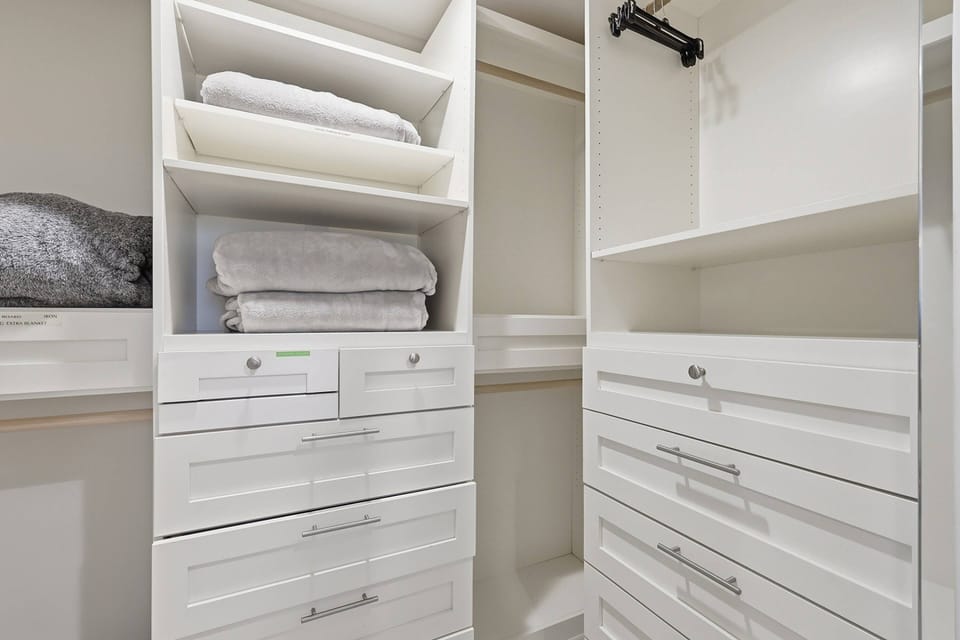 Don't worry about packing lightly, the primary's walk-in closet has plenty of space and storage for your belongings.