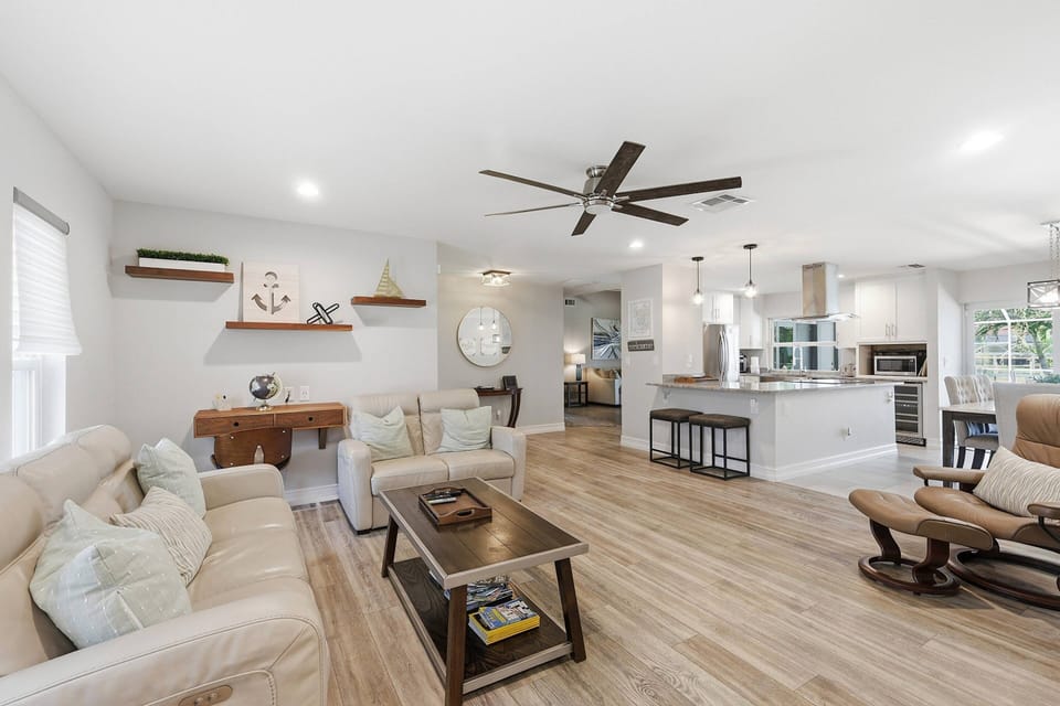 The open-concept layout keeps conversations flowing, connecting the living room, dining area, and beautifully updated kitchen into one inviting space.