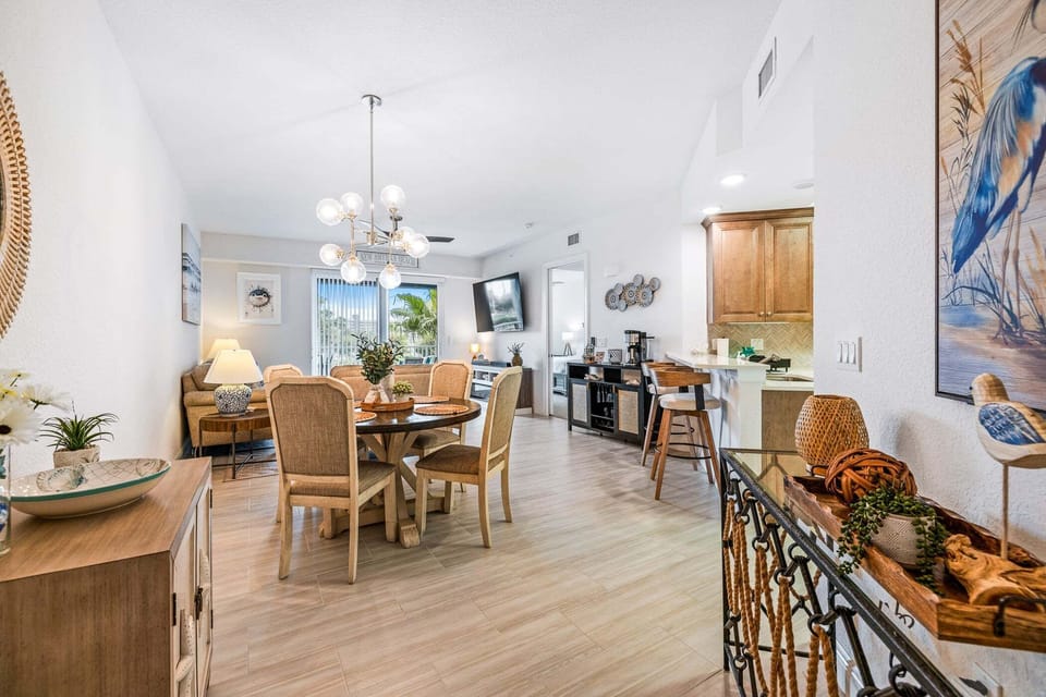 Relax, dine, and gather in this bright open-concept living area filled with coastal charm.