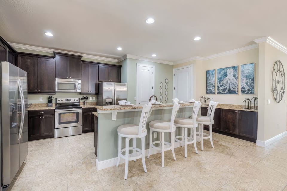 Fully equipped kitchen featuring modern appliances, expansive counter space, and a large center island.