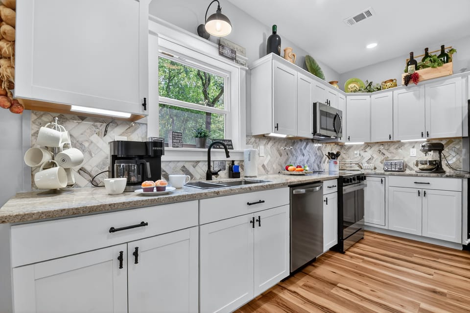 Fully stocked kitchen featuring granite counters, custom cabinetry, and stainless steel appliances for easy vacation dining