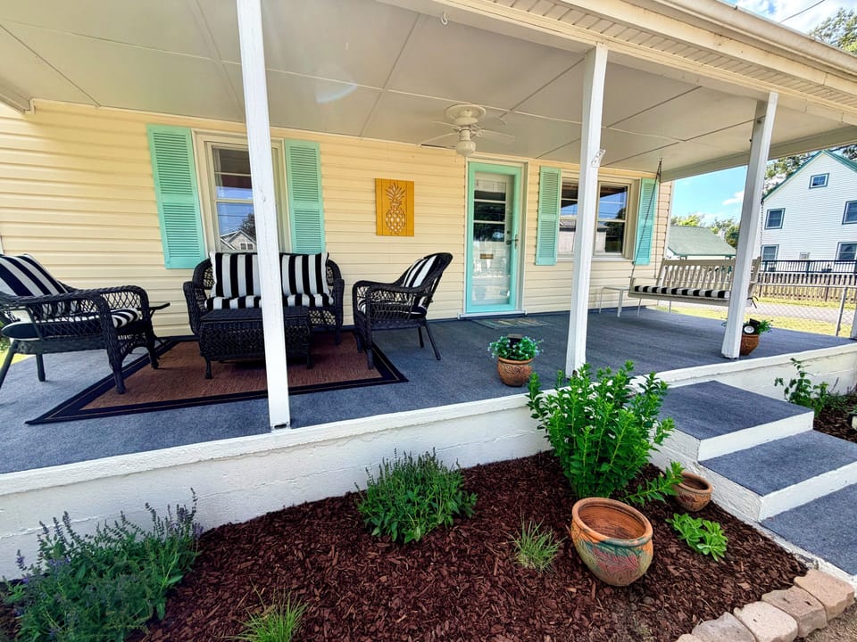 Covered porch with outdoor furniture and swing