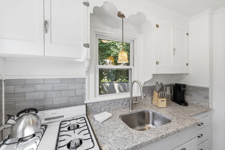 Updated kitchen with granite counters and sunny window views