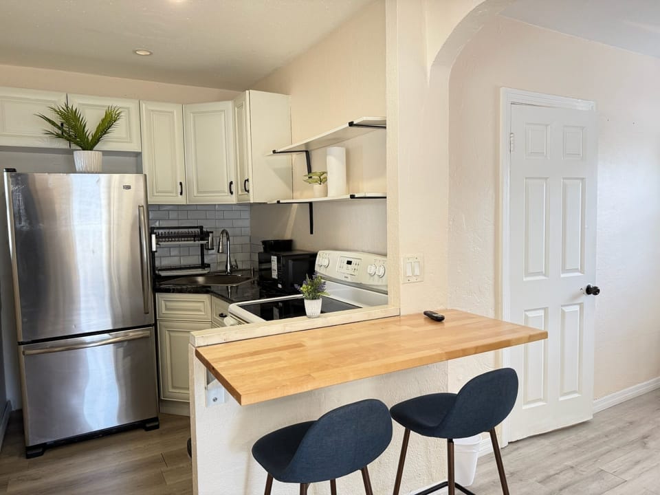 Bright updated kitchen with breakfast bar and stainless steel appliances