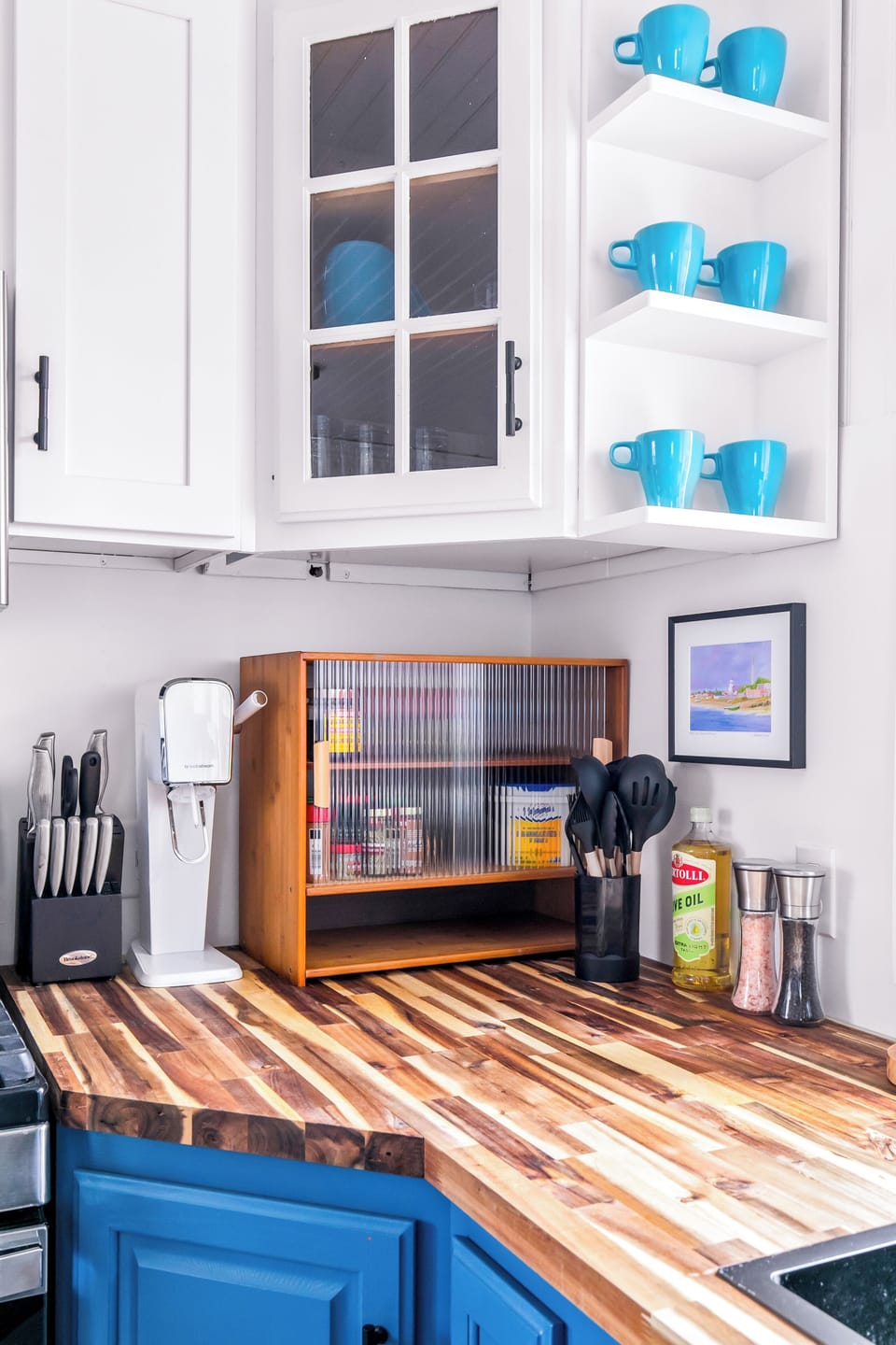 Bright kitchen nook with coffee station, open shelving, and stylish blue accents