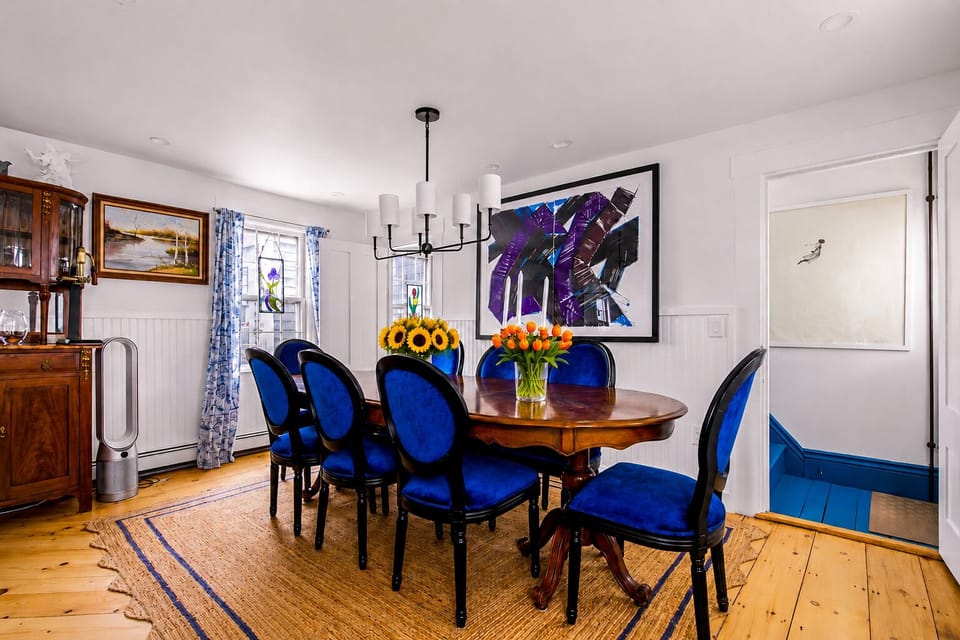 Bright dining room with elegant blue chairs and stylish artistic touches