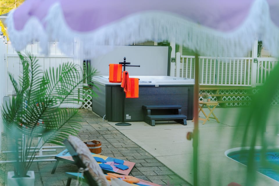 Enjoy year-round relaxation in the spacious hot tub overlooking the pool area