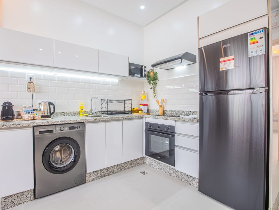 Bright modern kitchen with full appliances and in-unit washer