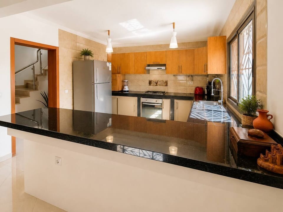 The heart of the villa: an open kitchen that keeps everyone connected, whether you're preparing dinner or planning tomorrow's adventures.