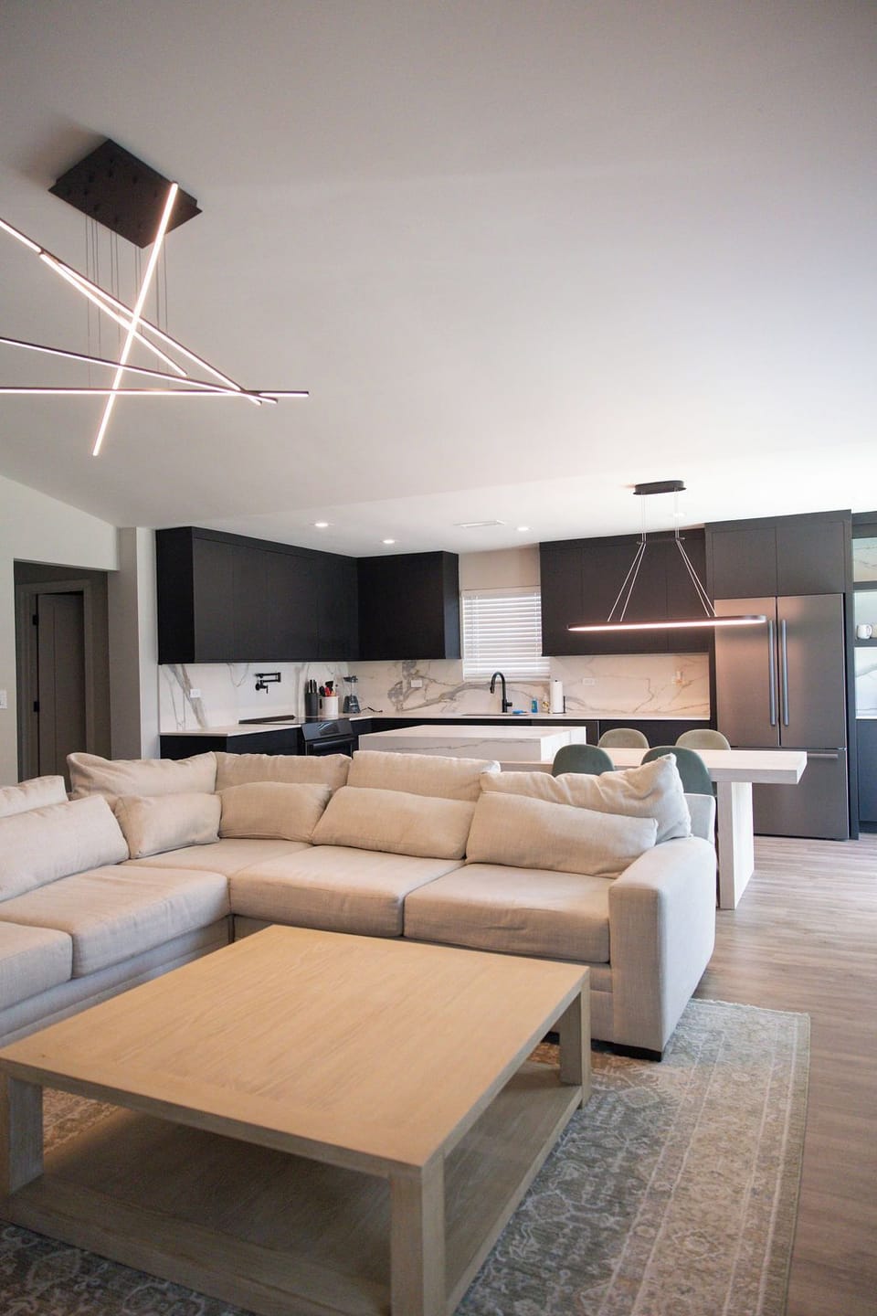 Modern open-concept living room and kitchen with spacious island seating