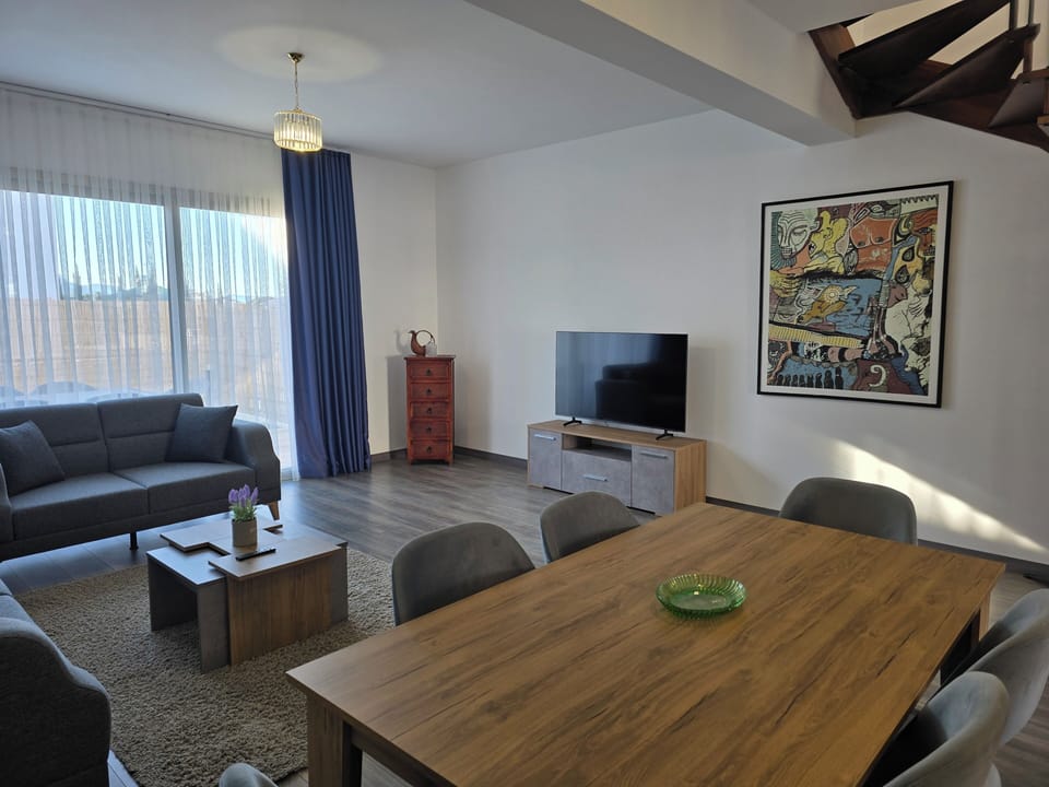 interior, indoor, couch, living area, television, dining table, daytime