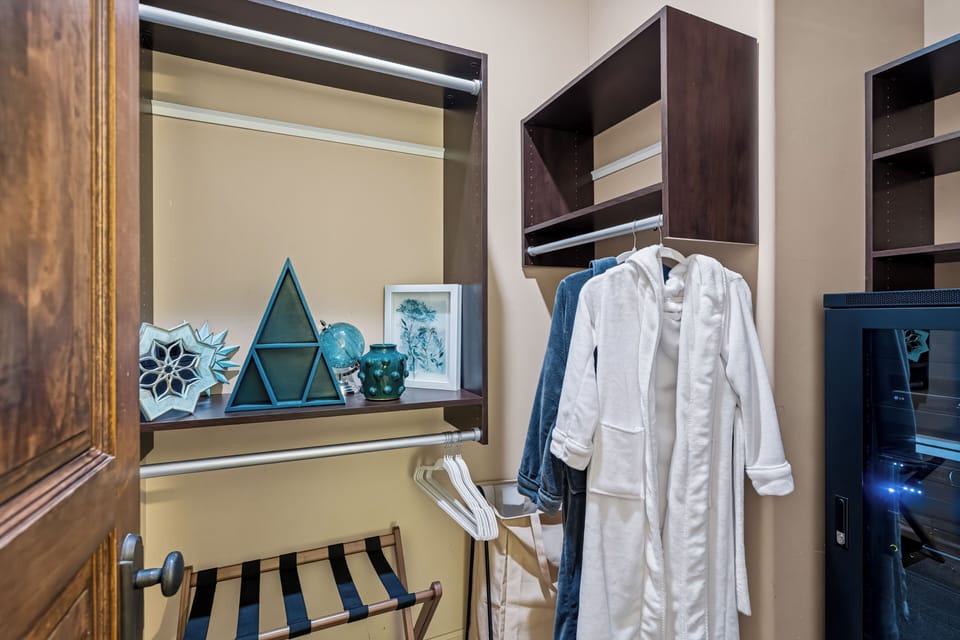 Spacious walk-in closet with robes, built-ins, and convenient luggage rack