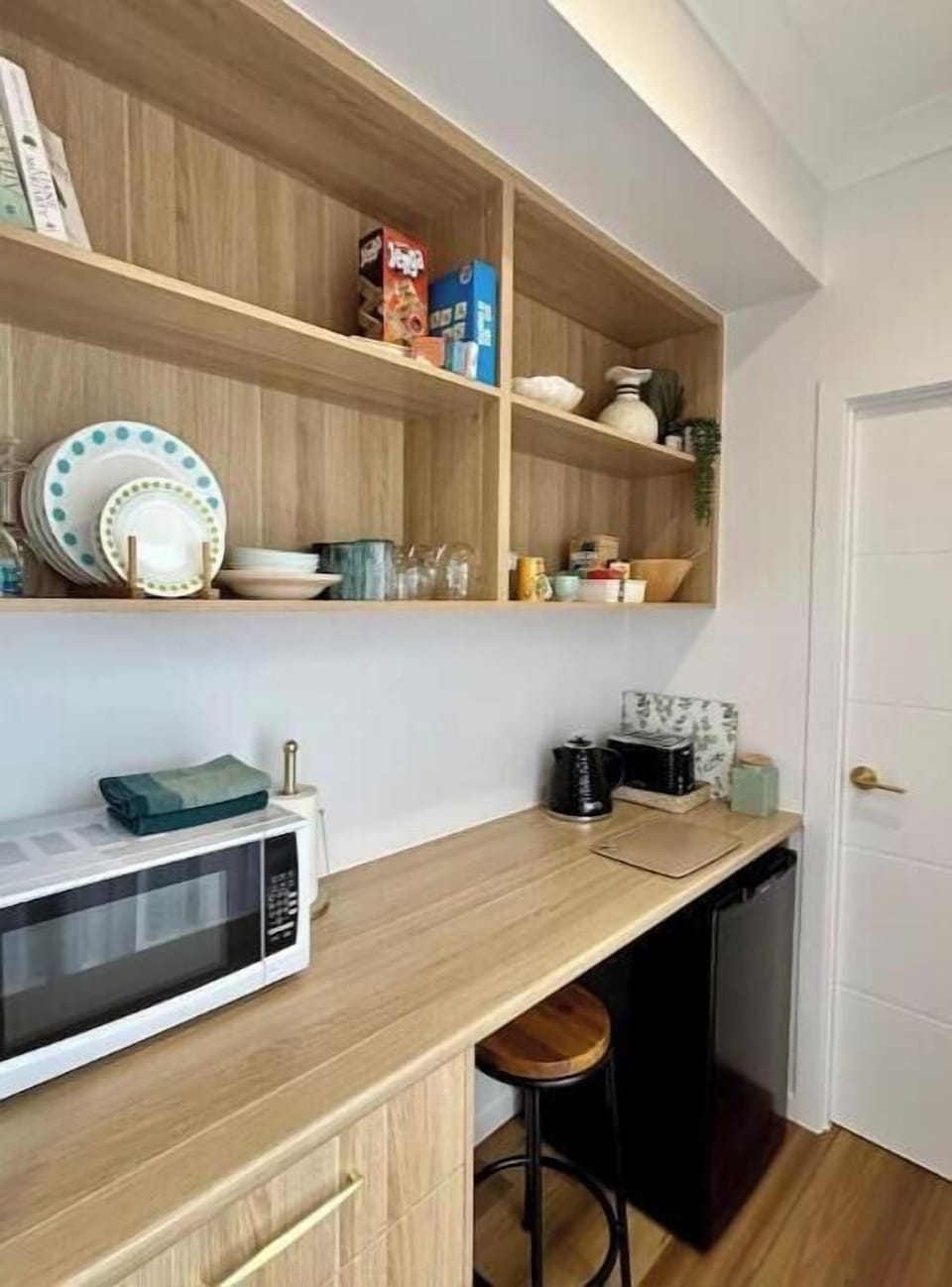 Mini kitchenette also doubles as a work desk with stool