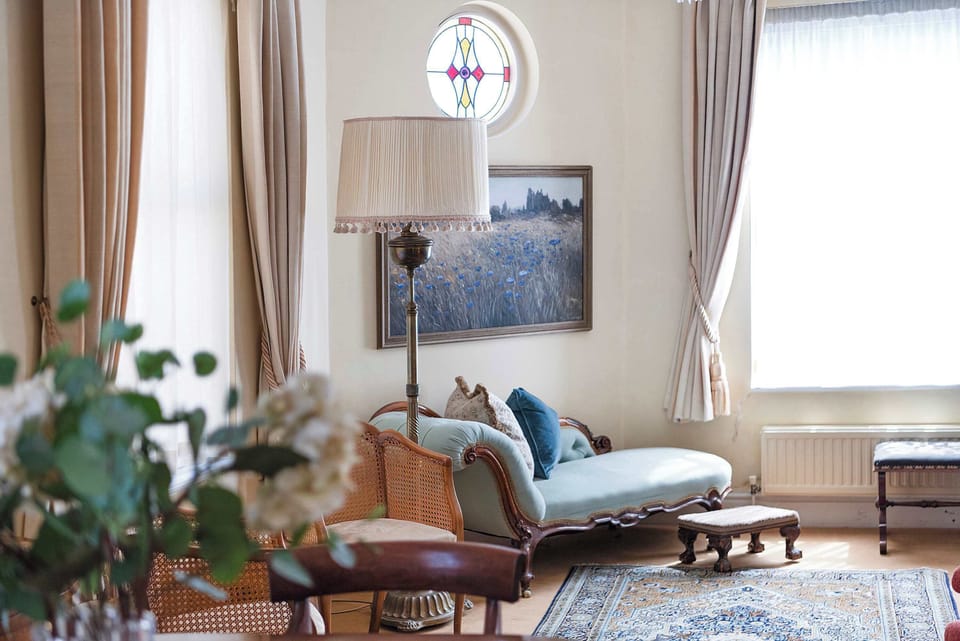 Relax in the elegant Victorian sitting lounge, beautifully furnished with traditional period-style furniture that reflects the home's historic character