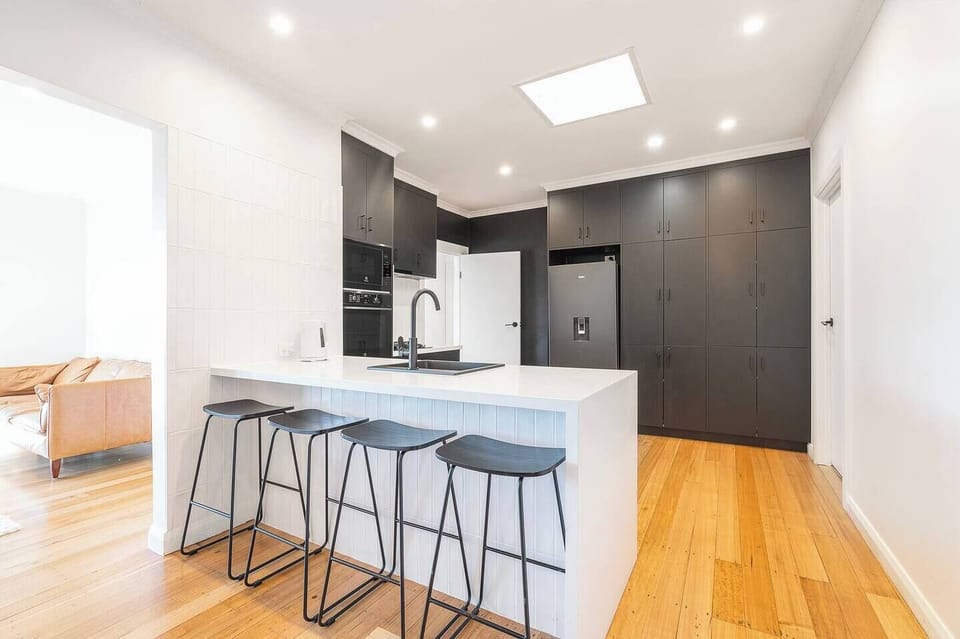 Start the day in the kitchen with coffee at the breakfast bar, where generous bench space makes everything from quick breakfasts to meal prep effortless.