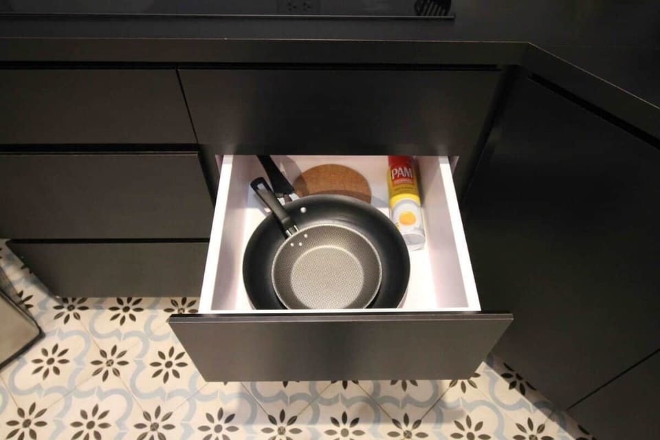 You'll find basic cooking tools like pans, pots, cutting boards, and more, all here for your convenience.