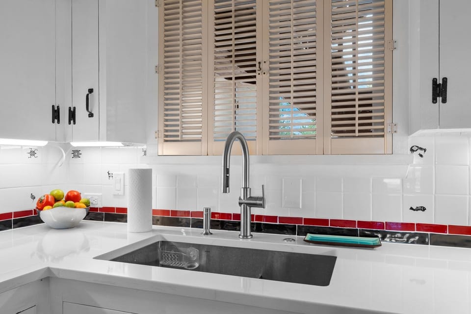 Bright modern kitchen with stylish tile accents and farmhouse charm