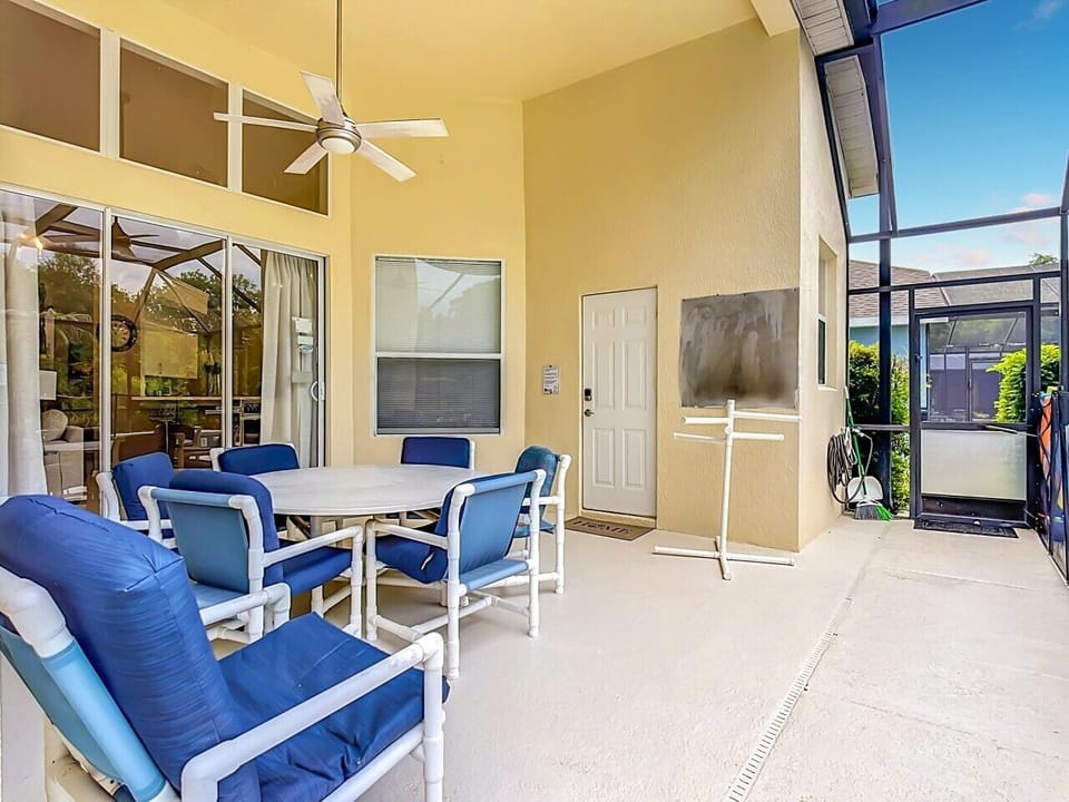 Covered lanai with outdoor dining and pool access