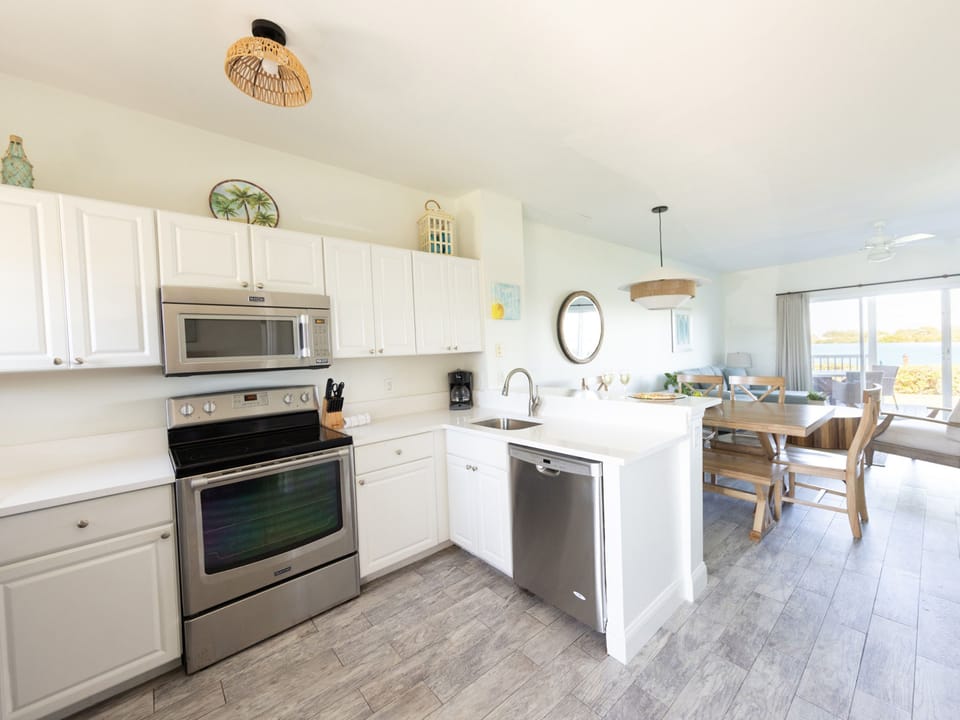Whip up coastal delicacies in a spacious kitchen, featuring modern appliances and an inviting dining area that beckons gathers over meals.