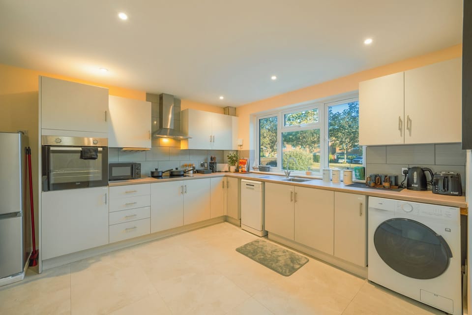 Bright, spacious kitchen with full appliances and large garden-view windows
