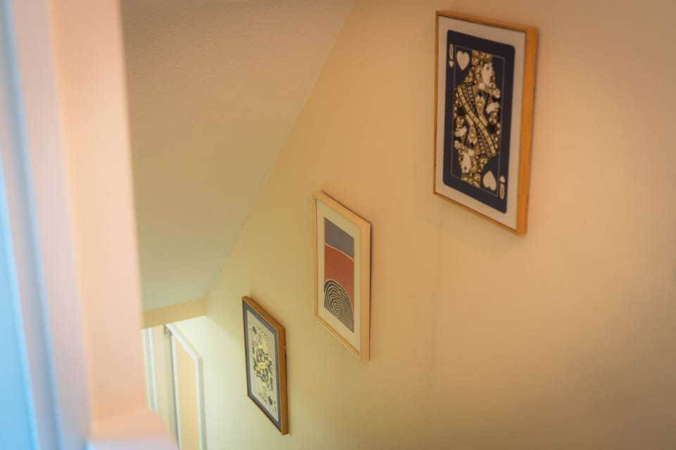 Bright stairwell with stylish artwork and warm, inviting character