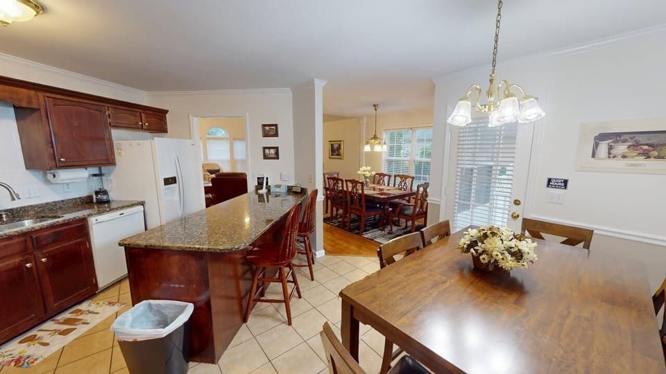 Breakfast area with seating for six, located next to the kitchen bar,