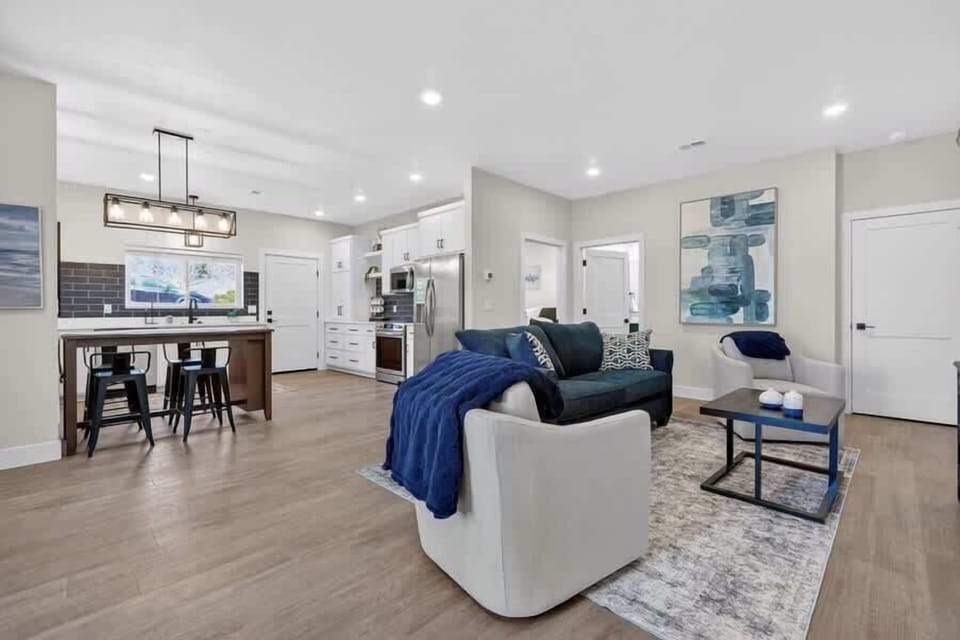 Lower level Unit: Step into your bright, open-concept retreat where contemporary style meets comfort. Relax on plush seating, prepare meals in a sleek modern kitchen, and make yourself at home in this inviting, thoughtfully designed space.